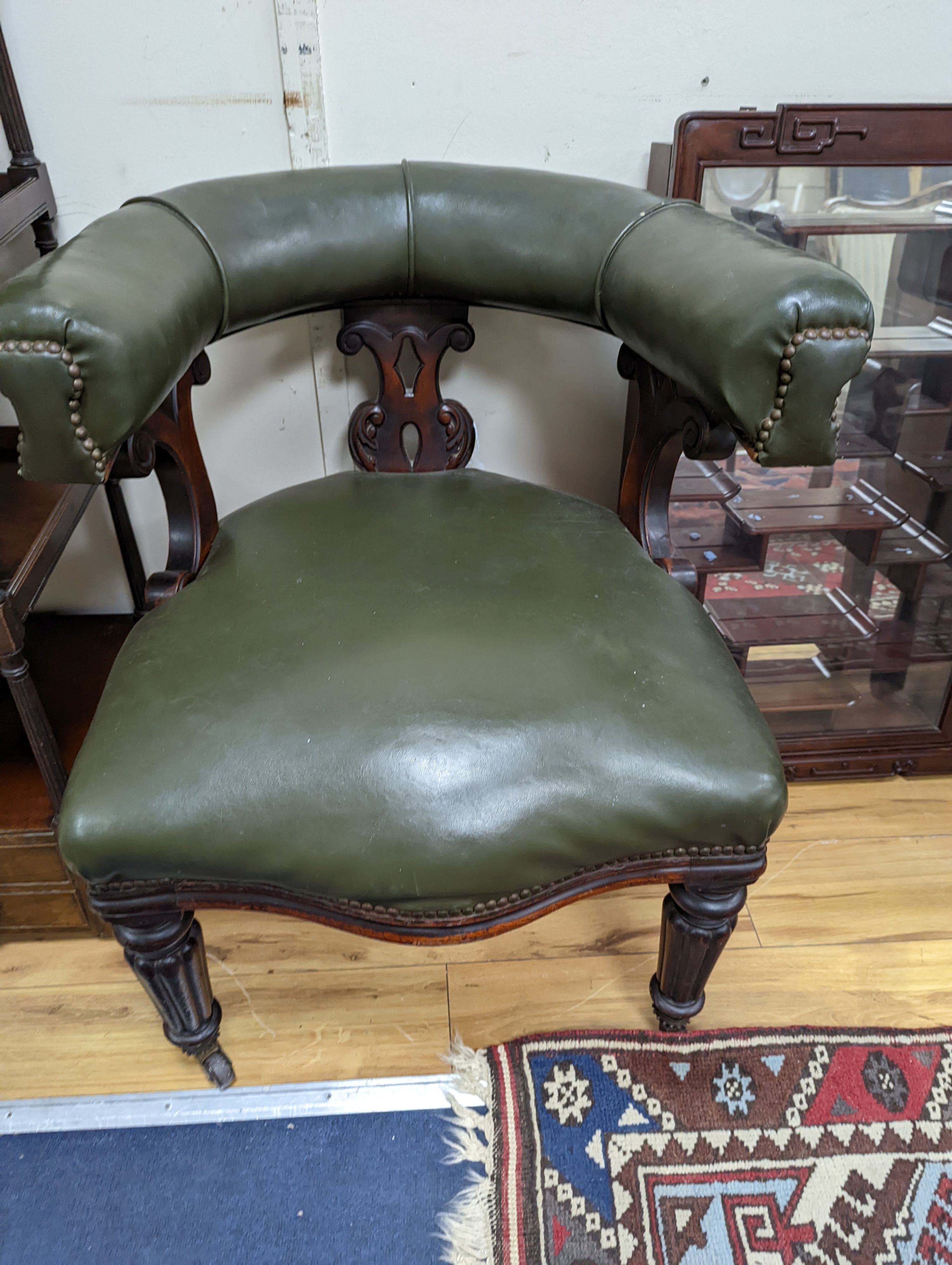 A Victorian mahogany tub framed chair upholstered in green leather, width 60cm, depth 58cm, height 66cm